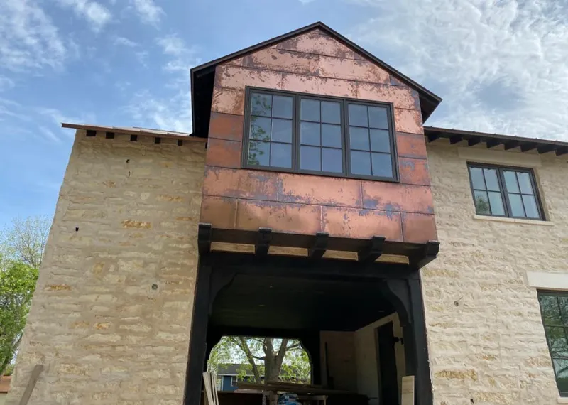 Copper metal panel facade on a stone building for Skylight Installation in Colusa